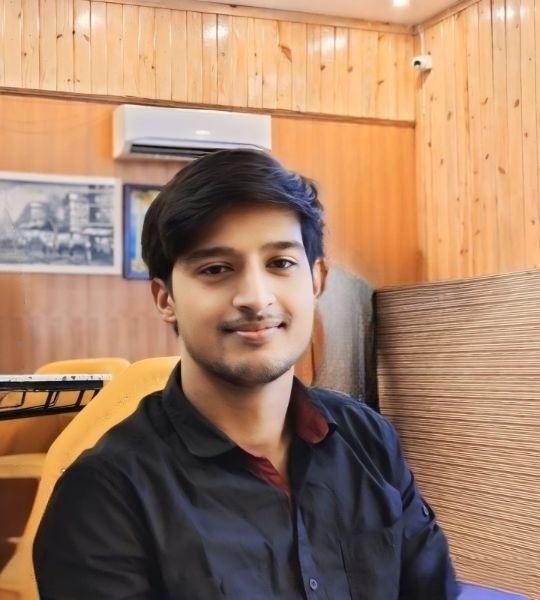 Professional portrait of a Java developer in a modern office setting, dressed in business casual attire, confident and approachable